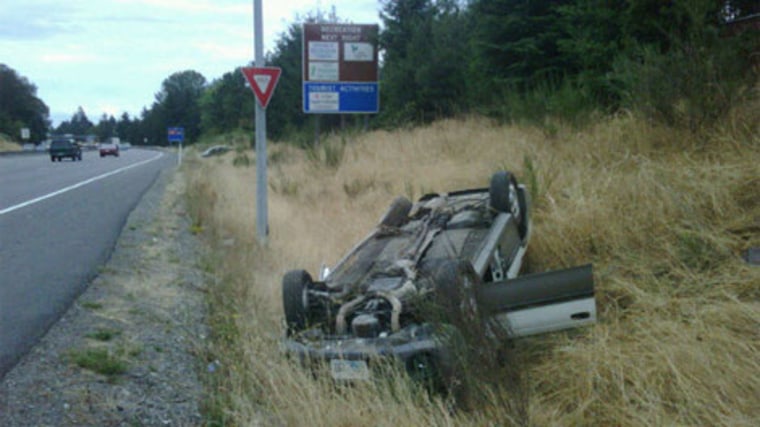 Image: Wrecked car lies upside down in ditch.